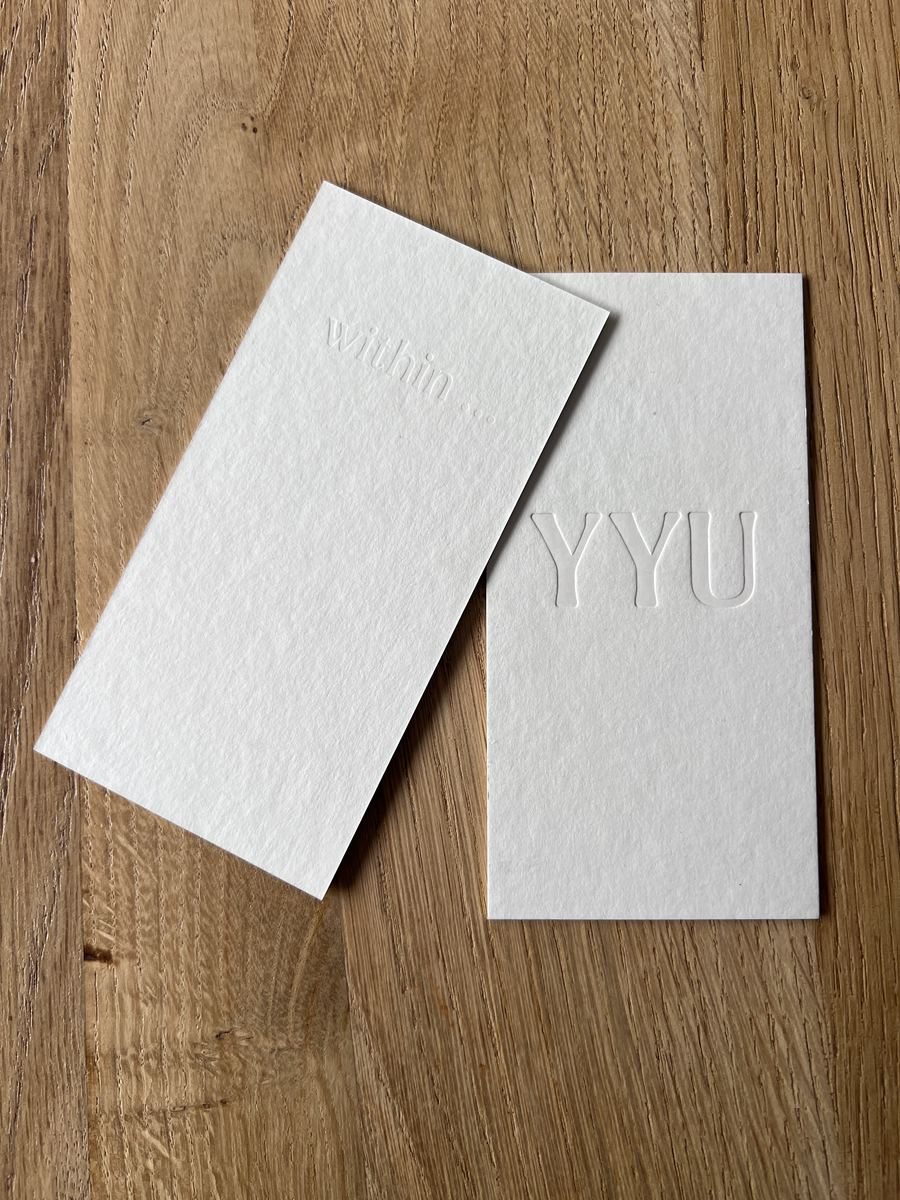 Both sides of the YYU keepsake on a wooden table